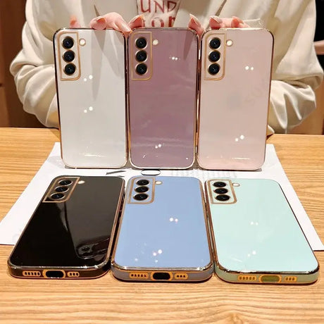 three iphones are sitting on a table