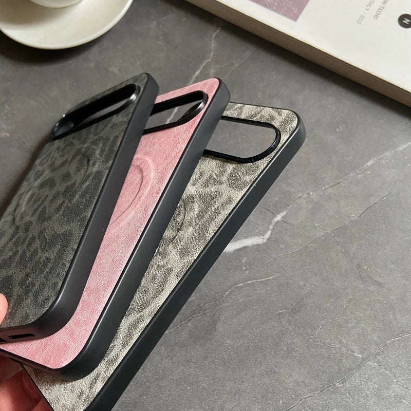 Three phone cases in black, pink, and gray with a subtle leopard print texture.