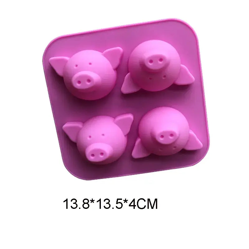 three pink pig shaped chocolate molds in a pink tray