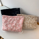 three small pouch bags with flowers on them