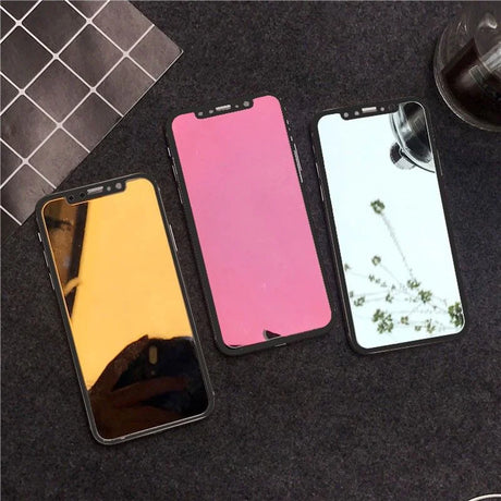 Three smartphones with colorful screens - yellow, pink, and mirrored silver.