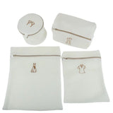 a set of three white bags with a gold zipper