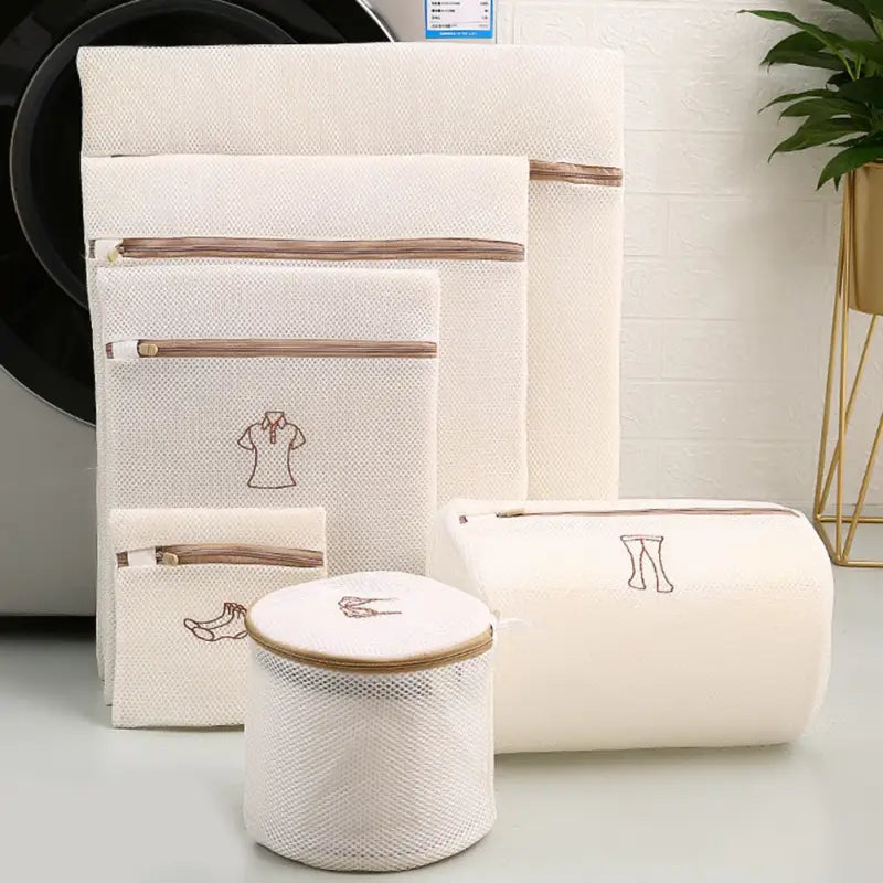 three white linen storage bags with a brown zipper
