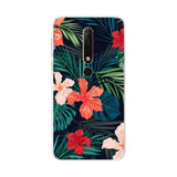 a phone case with tropical flowers and leaves