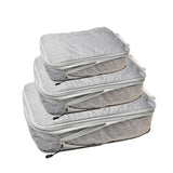 three grey bags with zippers on them