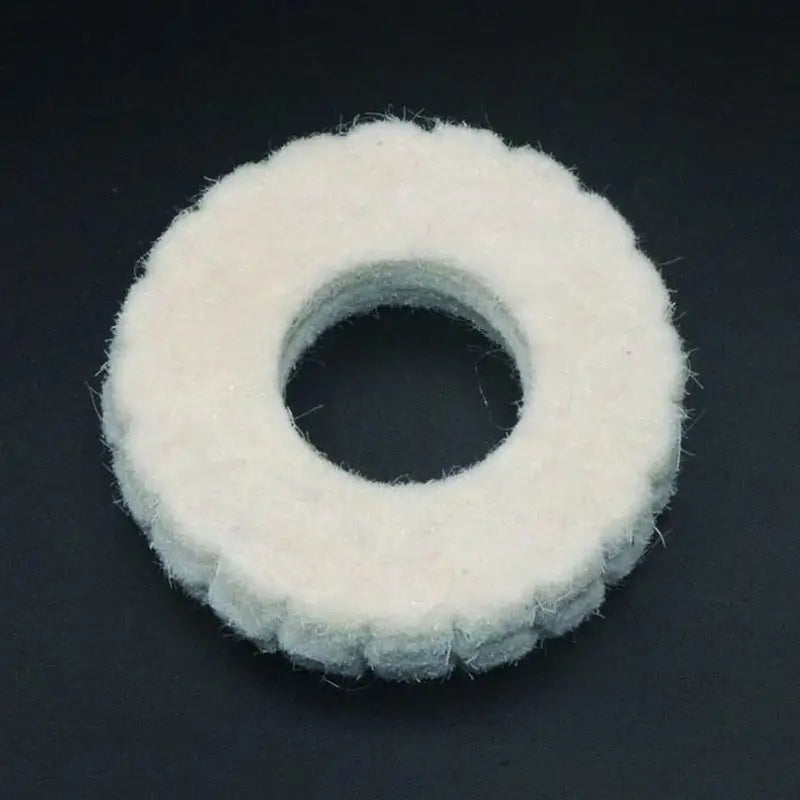 a white felt ring on a black background