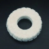 a white felt ring on a black background