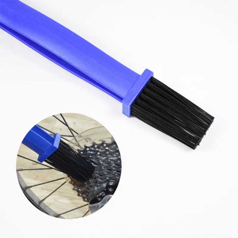 a blue brush with a black handle and a white background