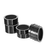 a pair of black carbon carbon pipe fittings