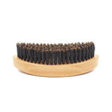 a wooden brush with black bristles on a white background