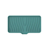 a green plastic tray with a wavy pattern