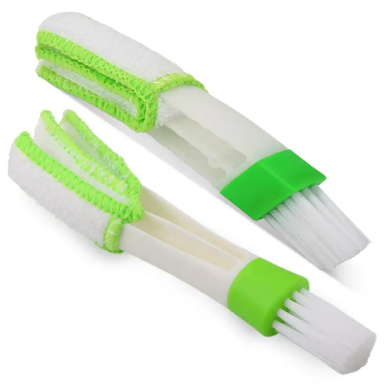 two white and green tooth brushes with green handles