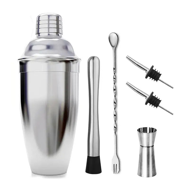 a close up of a cocktail shaker, a set of tongs, and a bottle