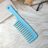 a blue comb with a white handle on a white fur