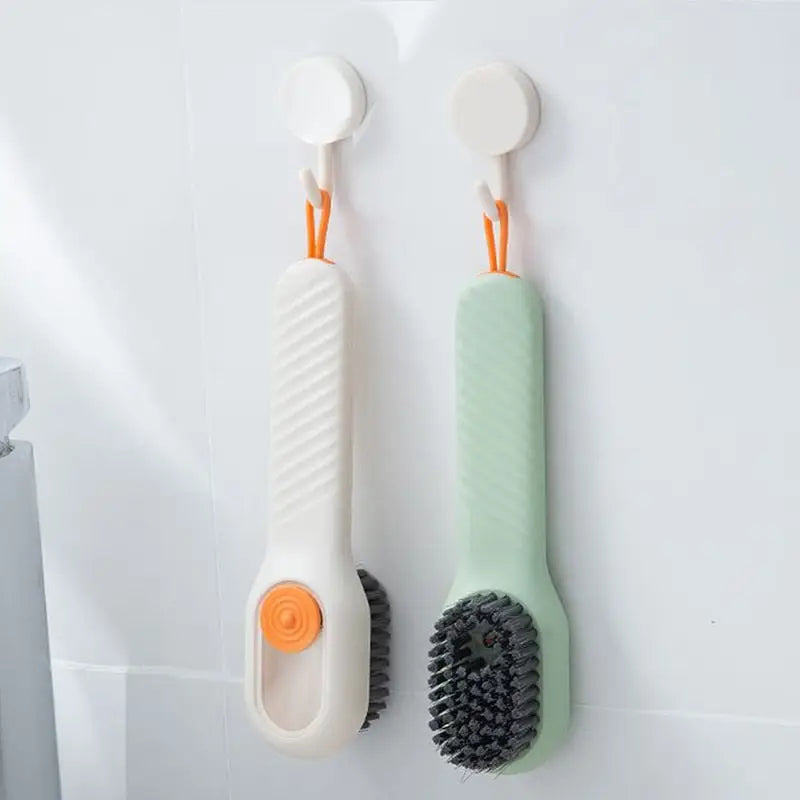 two tooth brushes hanging on the wall