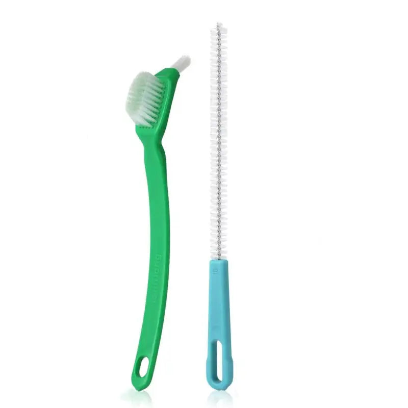 a green toothbrush and a white toothbrush