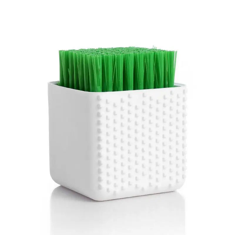 a toothbrush in a white container with green toothbrushs