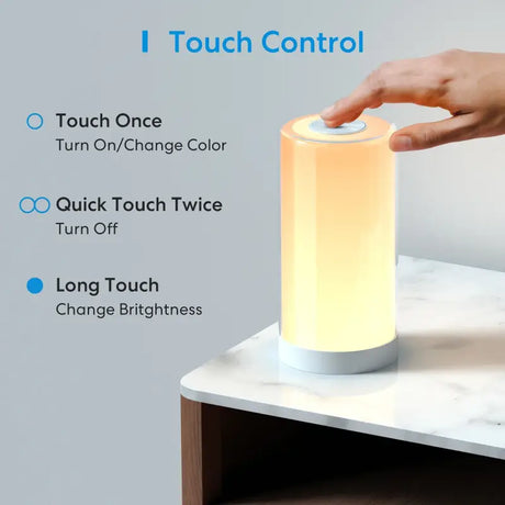 Someone is touching the touch control on a lamp on a table