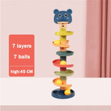 a toy tower with a teddy bear on top