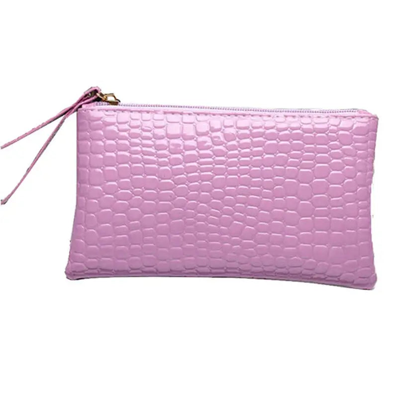 a pink crocodile skin leather clutch bag