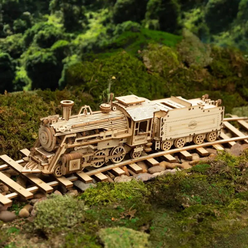 a model train is shown on a wooden platform