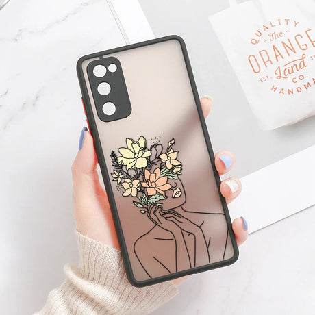 Translucent samsung galaxy phone case with black frame and line art design of woman’s face with yellow and peach flowers on back
