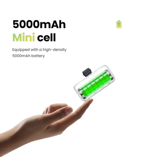 Transparent battery cell with green interior floating above an outstretched hand.