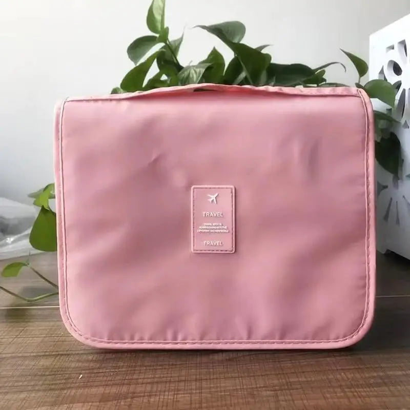 a pink cosmetic bag sitting on a table