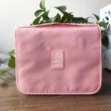 a pink cosmetic bag sitting on a table