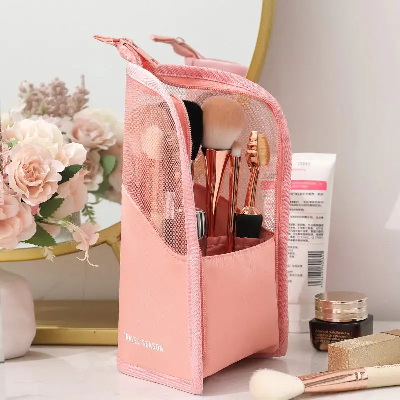 a pink makeup bag with makeup brushes and blushes