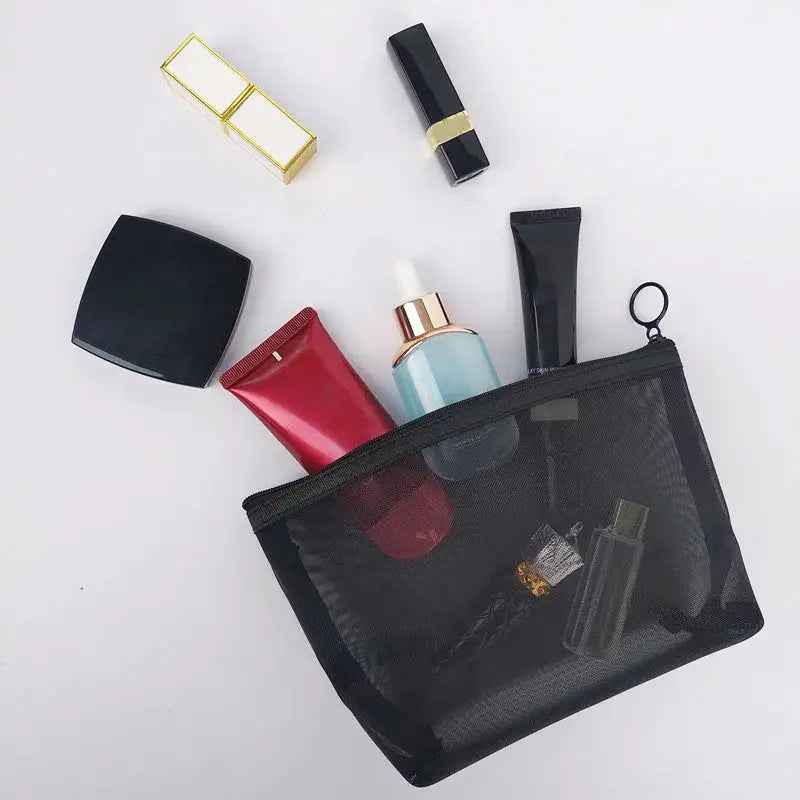 a black bag with various makeup products