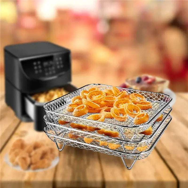 there are two baskets of food on a table with a digital air fryer