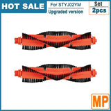 Two black and orange brushes with a red handle on a white background