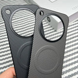 Two carbon fiber phone cases with circular camera cutouts.