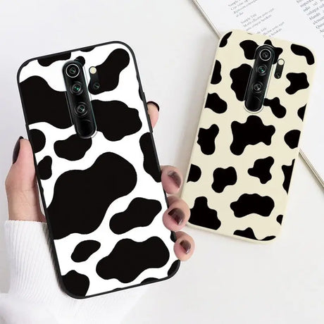 Two cases with black and white cow print on them