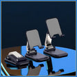 two cell phones on a table with a blue background
