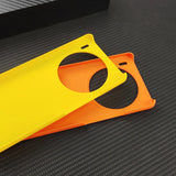 Two colorful smartphone cases, one yellow and one orange, with circular camera cutouts.