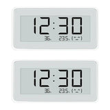 two digital clocks with thermometers on them