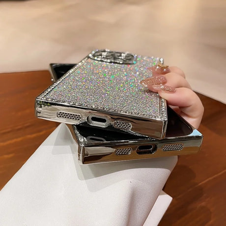 Two glittery silver smartphone cases with chrome edges.