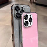 Two glittery smartphone cases, one gray and one pink, with prominent camera cutouts.
