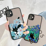 Two iPhone cases featuring artistic designs with black cats and flowers.