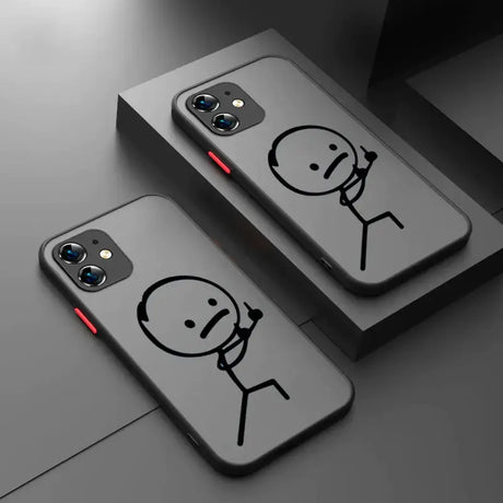 Two iphone cases with a face drawn on them