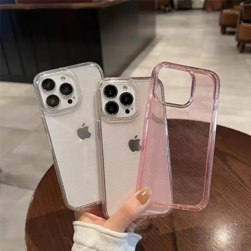 two iphone cases with glitter on them