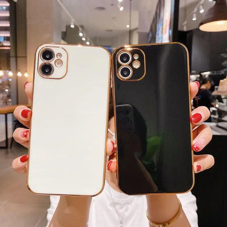 Two iPhone cases with gold trim.