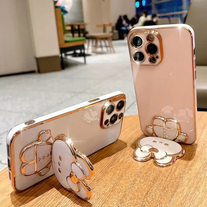 two iphones with a gold ring on them