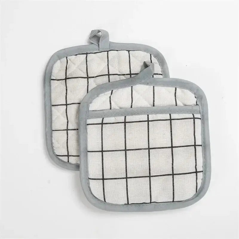 two oven mits with a black and white grid pattern