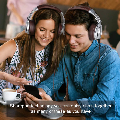 Two people wearing headphones and looking at a smartphone together.
