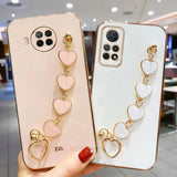 two phone cases with heart charms