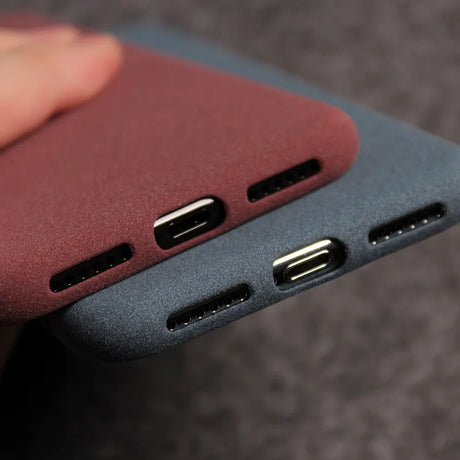 Two phone cases with port cutouts.