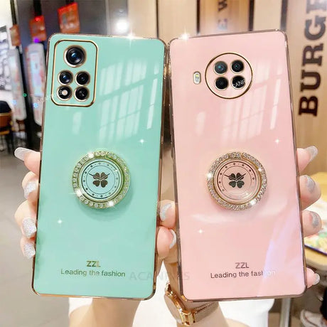 two phone cases with a phone ring on the back